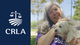 Woman smiling and holding dog