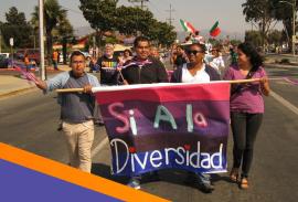 people carry a banner reading si a la diversidad in a Pride parade