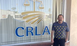 A client stands in front of the CRLA El Centro office