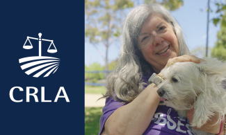 Woman smiling and holding dog