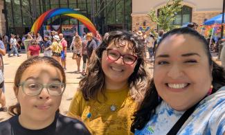 Three people smile during Pride 2026 celebration in Oakdale, California