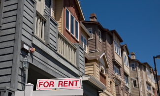 Housing complex with a for rent sign in front 
